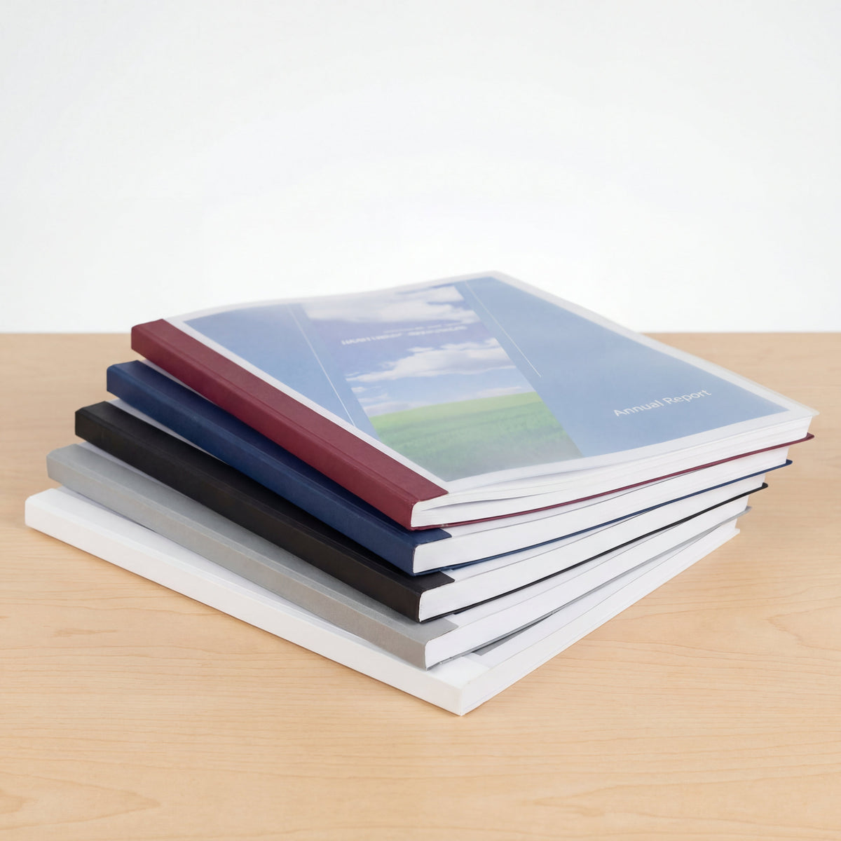 Reports bound in CoverBind linen thermal binding covers with clear fronts